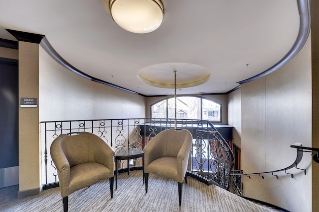 living area with light carpet and ornamental molding