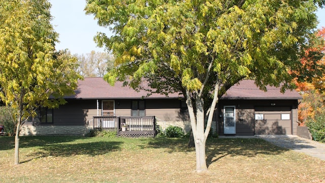 view of front of home with a front yard, a garage, and a wooden deck