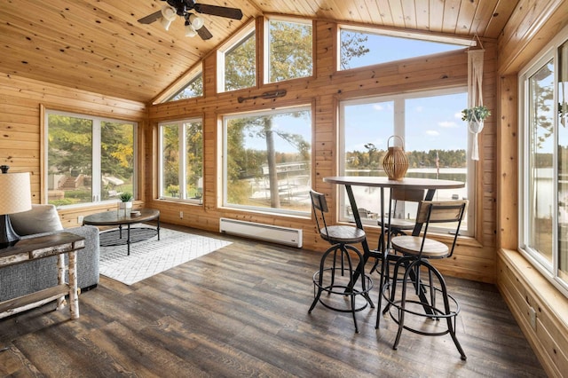 sunroom / solarium featuring wooden ceiling, vaulted ceiling, a baseboard heating unit, and a wealth of natural light