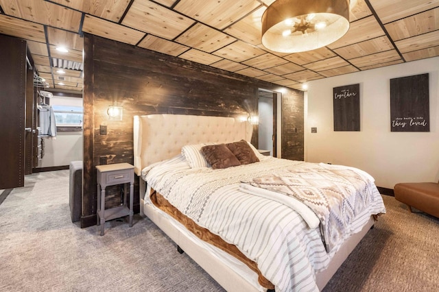 bedroom featuring carpet flooring and wooden walls