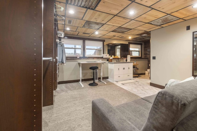 living room with wood ceiling, sink, and light carpet