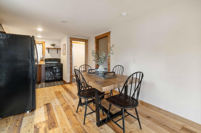 dining area featuring light wood-type flooring