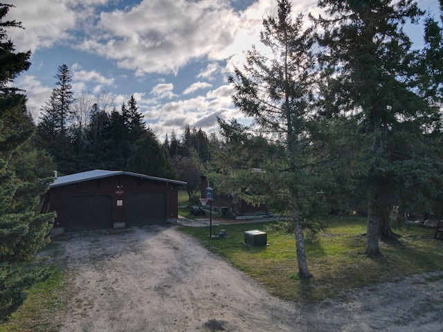 exterior space with a garage and an outdoor structure