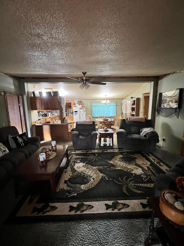 living room featuring ceiling fan with notable chandelier and a textured ceiling