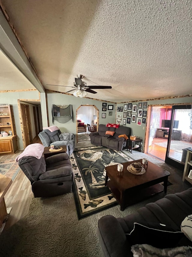 living room with ceiling fan and a textured ceiling