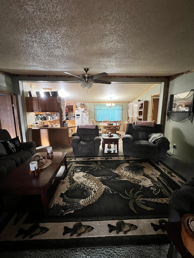 carpeted living room featuring ceiling fan with notable chandelier and a textured ceiling