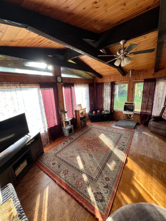 unfurnished living room featuring ceiling fan, wood-type flooring, heating unit, wood ceiling, and vaulted ceiling with beams