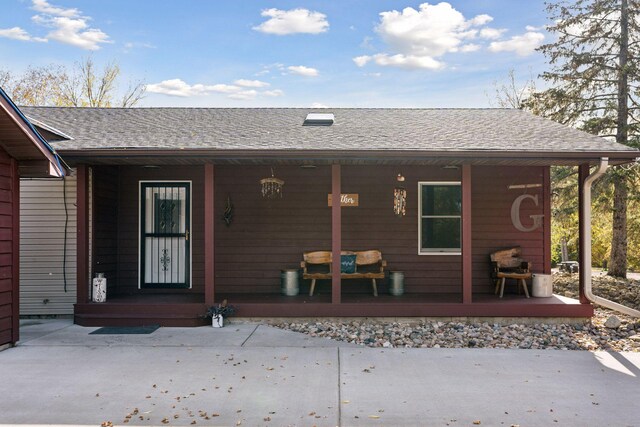 back of property with a porch