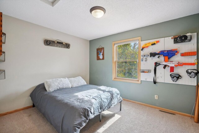 bedroom with carpet and a textured ceiling