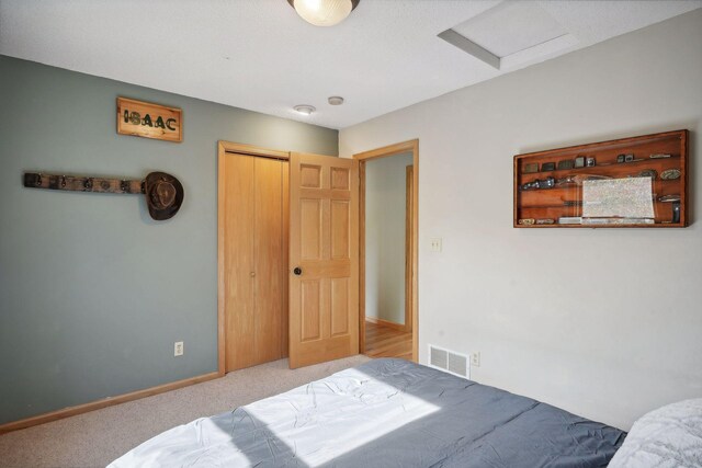 bedroom featuring light carpet and a closet