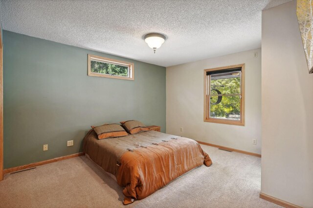 carpeted bedroom with a textured ceiling