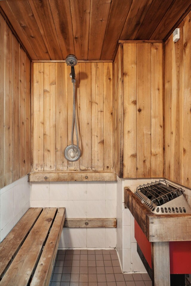 view of sauna featuring wood walls, wooden ceiling, and tile patterned floors