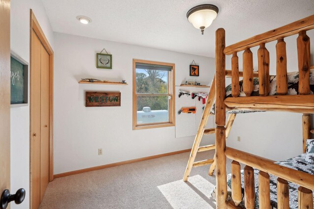 bedroom featuring carpet flooring and a textured ceiling