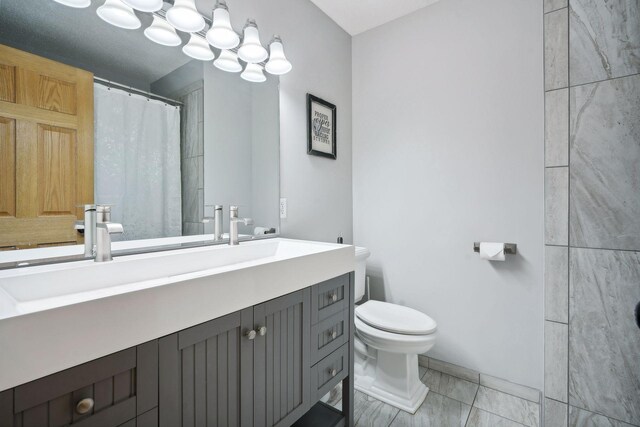 bathroom with walk in shower, vanity, toilet, and tile patterned floors