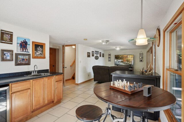 dining area featuring beverage cooler, wet bar, and light tile patterned floors