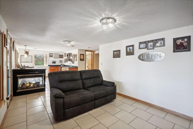 living room with light tile patterned floors and a textured ceiling