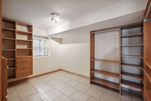 spacious closet with light tile patterned floors