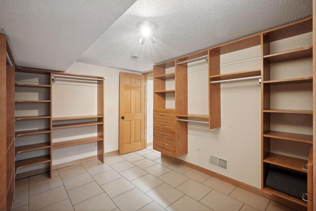 walk in closet featuring light tile patterned floors