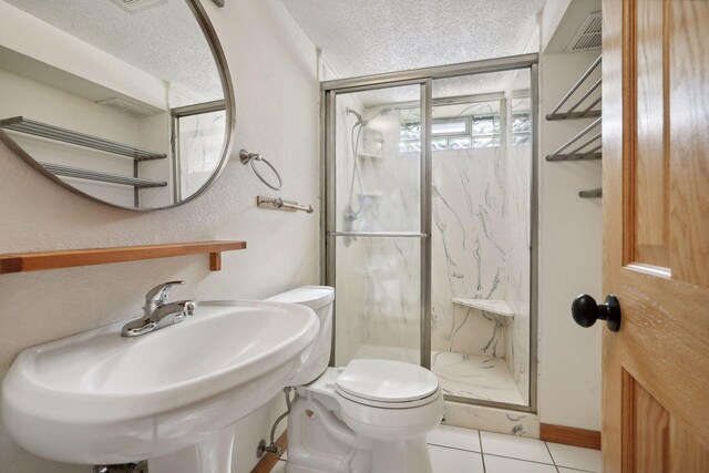 bathroom featuring an enclosed shower, tile patterned flooring, toilet, and a textured ceiling