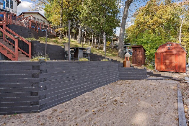 view of yard with a deck and a storage shed