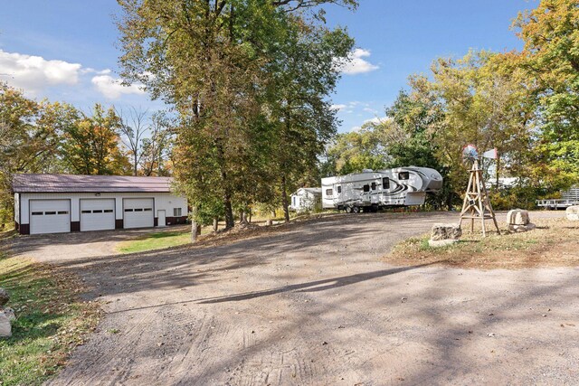 exterior space featuring a garage and an outbuilding