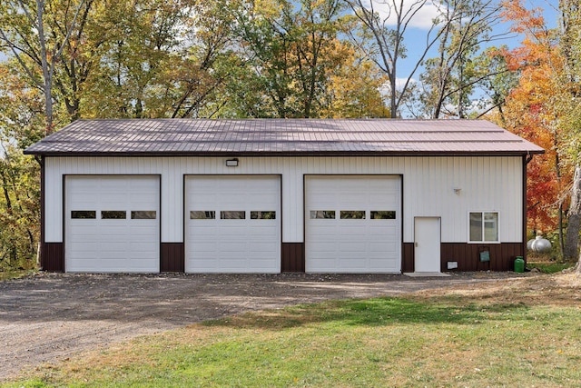 garage with a yard and wooden walls