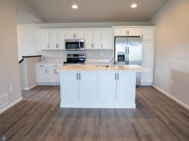 kitchen with appliances with stainless steel finishes, white cabinetry, and dark wood-type flooring