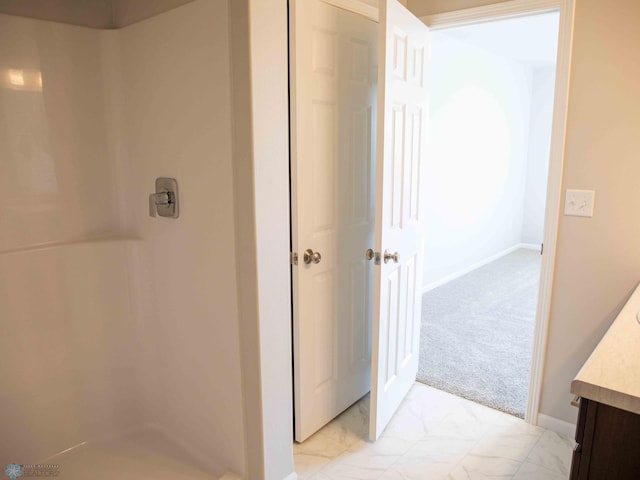 6329 83rd Ave S, Horace, ND 58047 - full bathroom featuring vanity, a walk in shower, marble finish floors, and baseboards