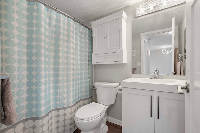 bathroom featuring vanity, a shower with curtain, a textured ceiling, and toilet