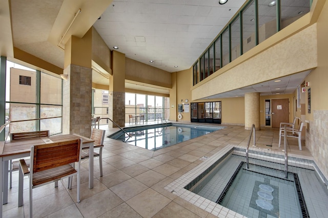 view of pool with an indoor hot tub