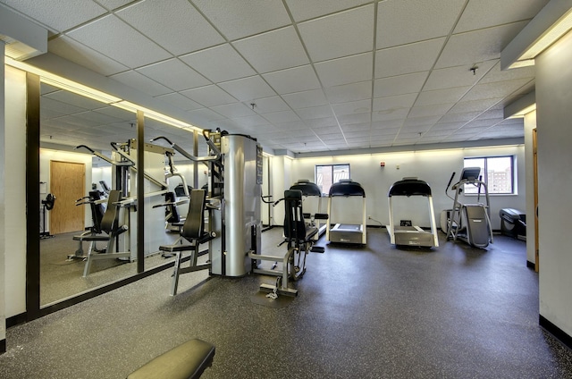 workout area with a wealth of natural light and a paneled ceiling