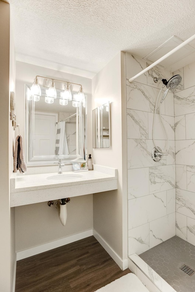 bathroom featuring a textured ceiling, walk in shower, sink, and hardwood / wood-style floors