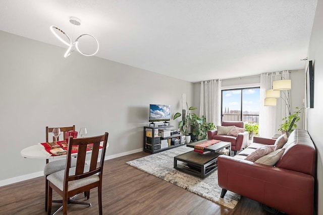 living room with dark hardwood / wood-style floors and a textured ceiling