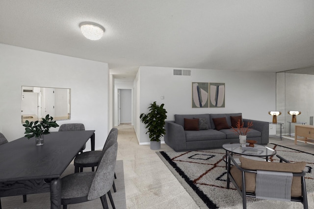 7500 Cahill Rd Unit 202C, Edina, MN 55439 - living room with light colored carpet, a textured ceiling, and baseboards