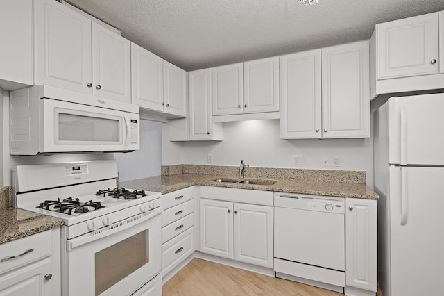 7500 Cahill Rd Unit 202C, Edina, MN 55439 - kitchen featuring white appliances, a sink, white cabinetry, and a textured ceiling