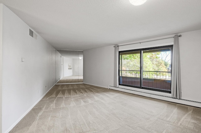 7500 Cahill Rd Unit 202C, Edina, MN 55439 - unfurnished room featuring carpet flooring, a textured ceiling, a baseboard heating unit, and baseboards