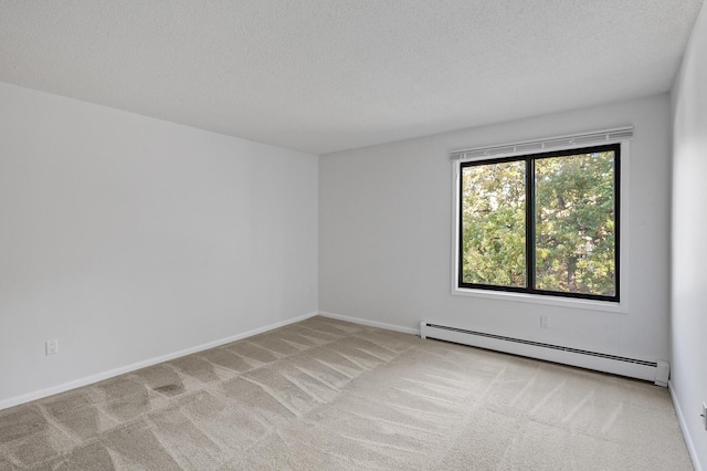 carpeted empty room featuring a textured ceiling and baseboard heating