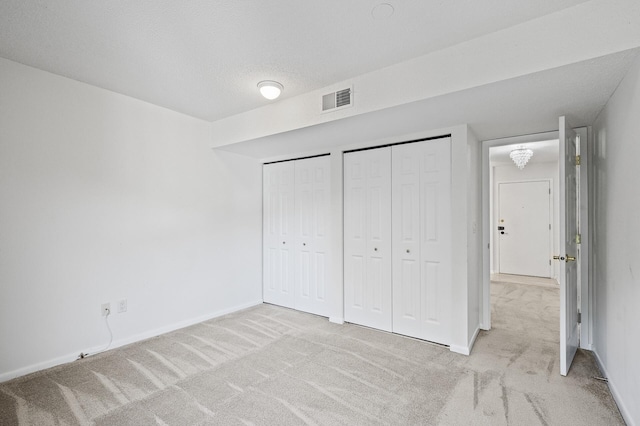 7500 Cahill Rd Unit 202C, Edina, MN 55439 - unfurnished bedroom with carpet flooring, two closets, and baseboards