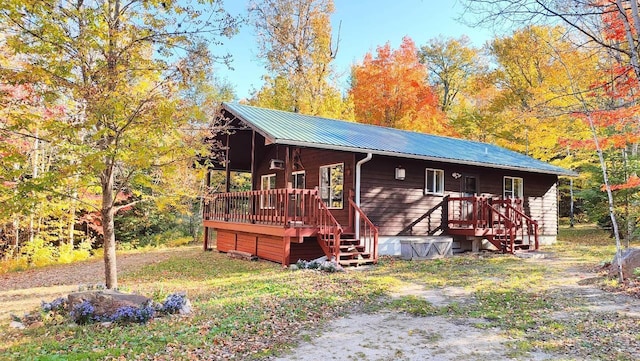 view of front of house featuring a deck and metal roof