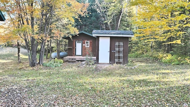 view of outbuilding featuring a yard