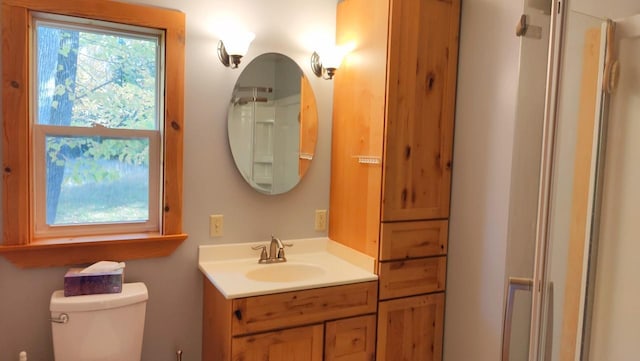 full bath with vanity, toilet, and a shower