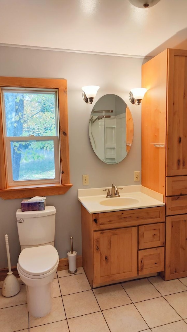 bathroom with vanity, tile patterned flooring, baseboards, and toilet