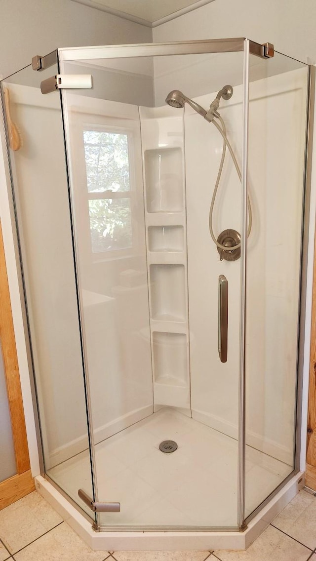 full bath featuring a shower stall and tile patterned flooring