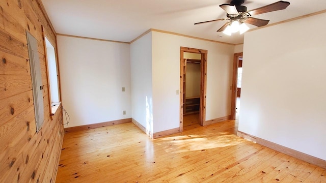 unfurnished bedroom with ceiling fan, crown molding, baseboards, a closet, and light wood-style flooring
