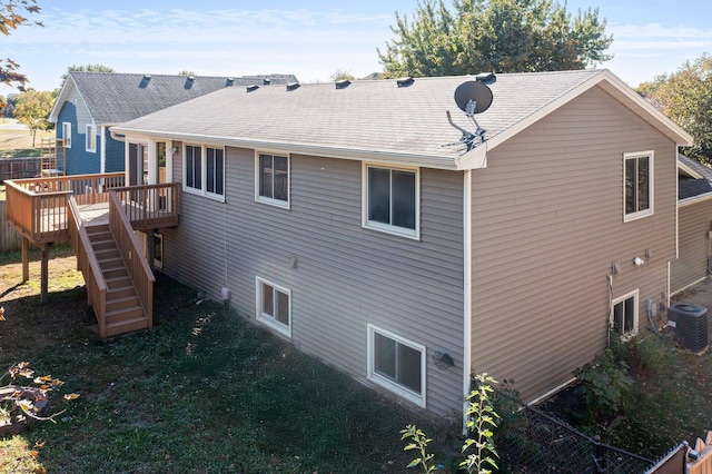 rear view of house featuring cooling unit and a deck