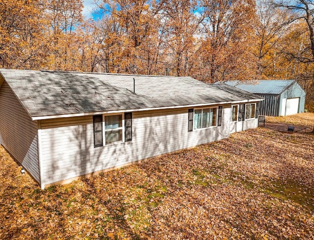 view of property exterior with a storage unit