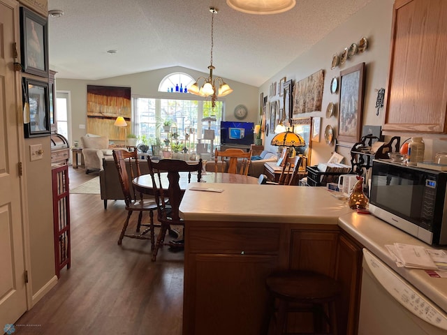 358 30th St N, Moorhead, MN 56560 - kitchen with a peninsula, wood finished floors, open floor plan, vaulted ceiling, and white dishwasher