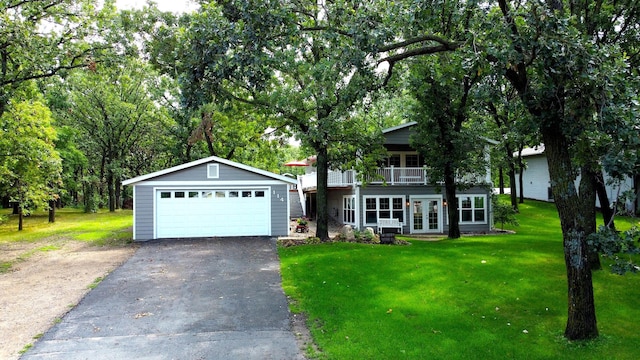 view of front of property with a front lawn, a balcony, and a garage