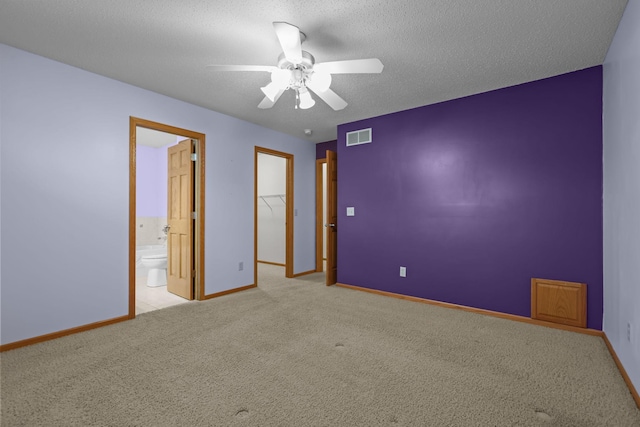 carpeted empty room featuring a textured ceiling and ceiling fan