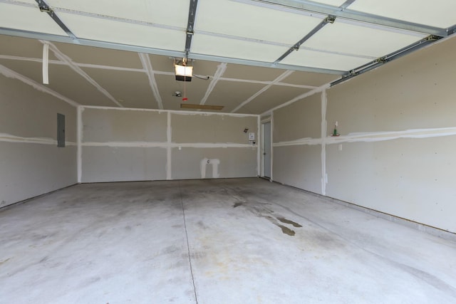 garage featuring electric panel and a garage door opener